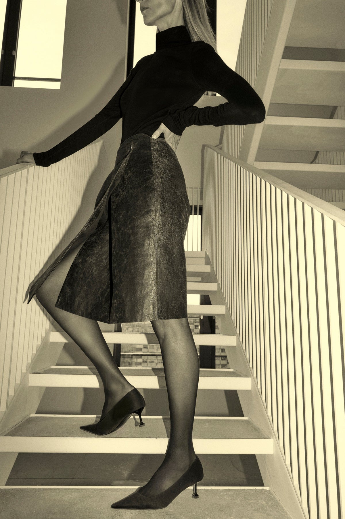 Styled view CAMILLA AND MARC Dawn Leather Skirt in Black Brown with a wrap midi silhouette.