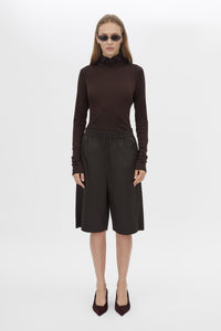 Front styled view CAMILLA AND MARC Barre High Neck Top in Chocolate with long sleeves and turtleneck silhouette.  