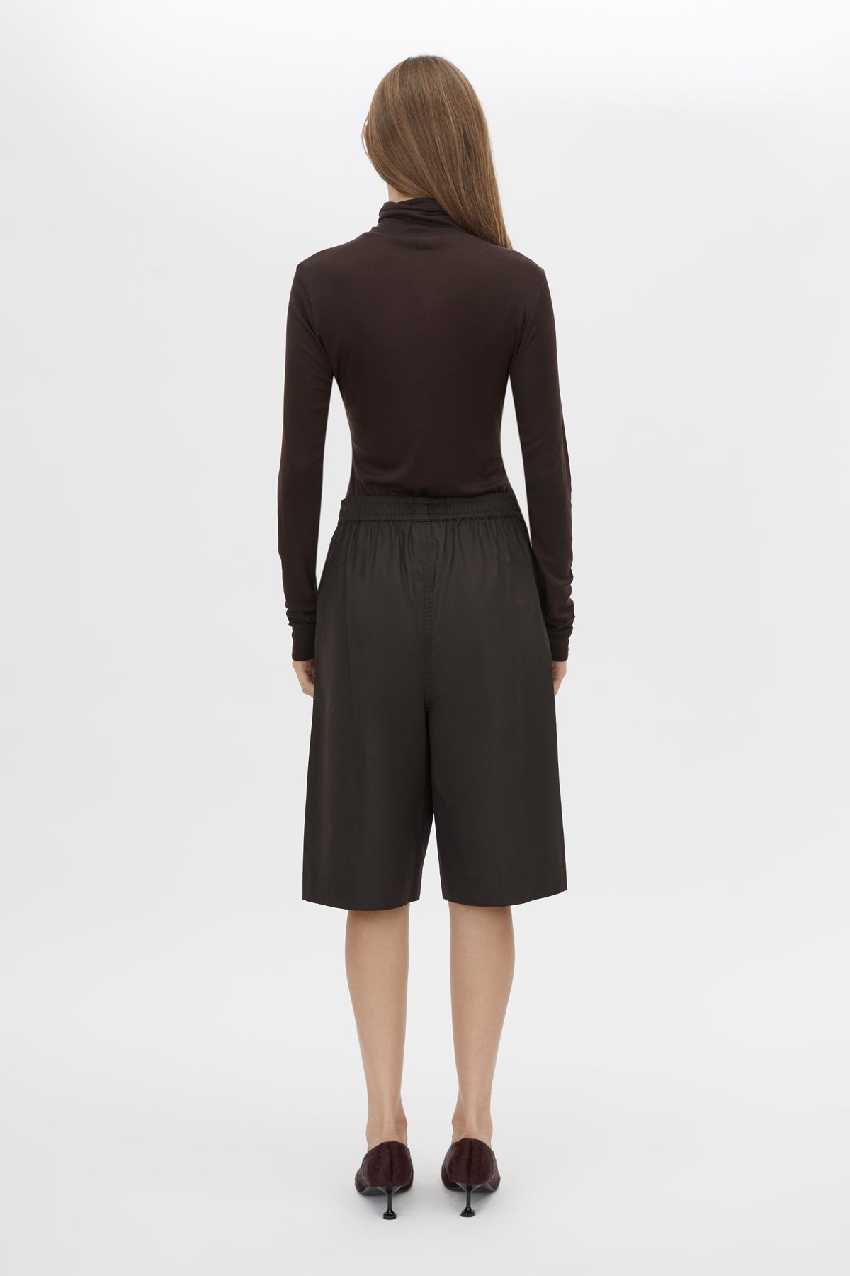 Back view CAMILLA AND MARC Barre High Neck Top in Chocolate with long sleeves and turtleneck silhouette.  