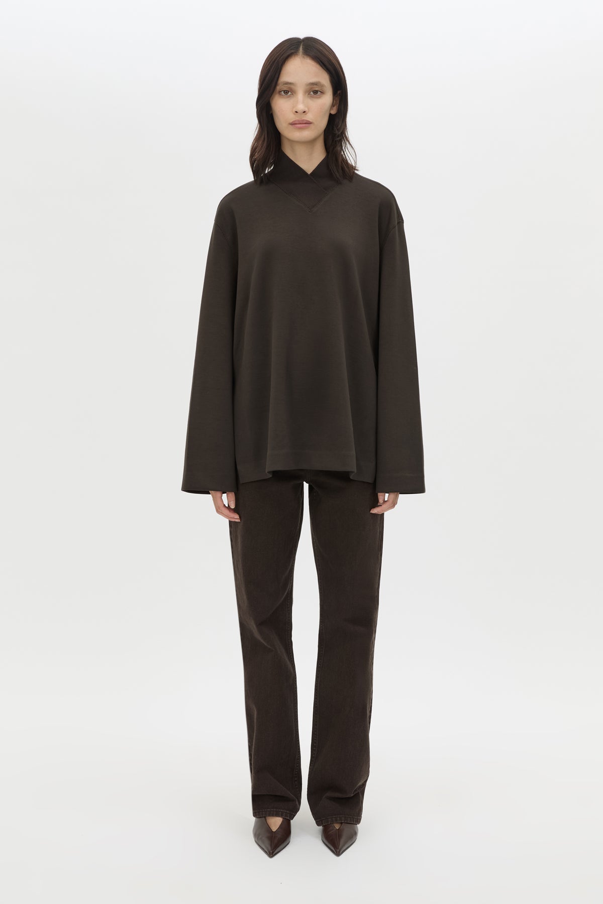 Side view CAMILLA AND MARC Bessette long sleeve top in espresso brown top with high neck. 