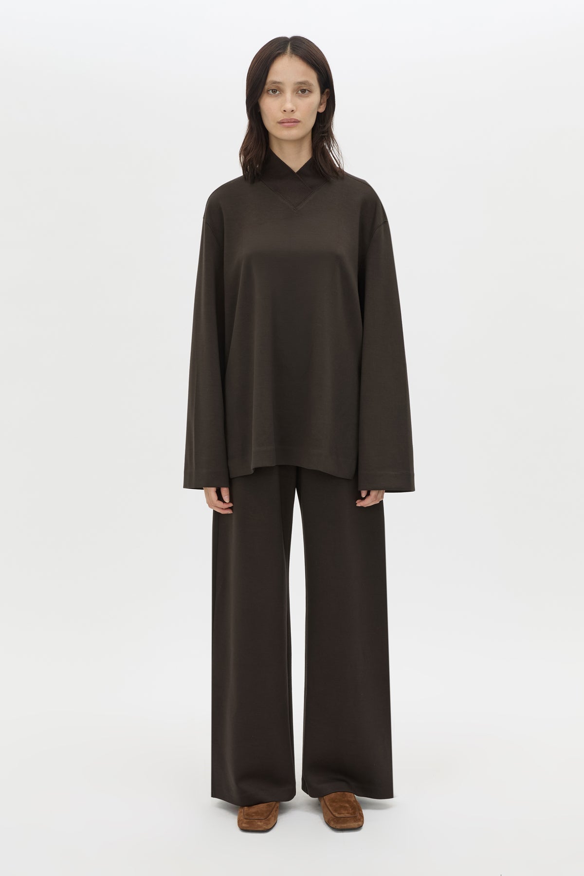 Front styled view CAMILLA AND MARC Bessette long sleeve top in espresso brown top with high neck. 