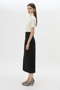 Side view CAMILLA AND MARC Caius High Corset Waist Midi Skirt in Black with structured waist.