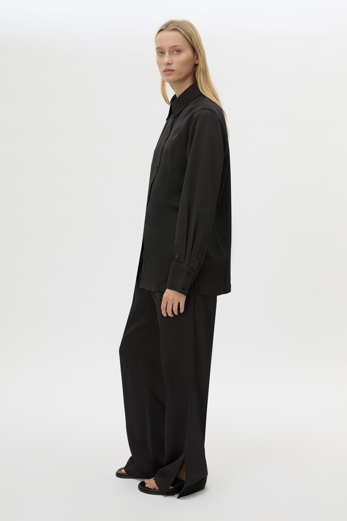 Side view CAMILLA AND MARC Ground Satin Long Sleeve Shirt in Black with collared neckline.