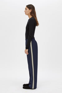 Side view CAMILLA AND MARC Locus Scuba Pant in Midnight with a mid‑rise fit and side‑stripe tape.