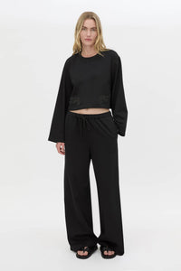 Front-styled view CAMILLA AND MARC Niami Crochet Cropped Top in black with cut‑away crochet detailing at hem.