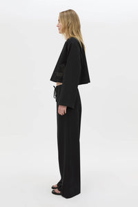 Side view CAMILLA AND MARC Niami Crochet Cropped Top in black with cut‑away crochet detailing at hem.