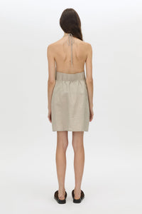 Back view CAMILLA AND MARC Phostre Halter Mini Dress in sand with a halter neckline.