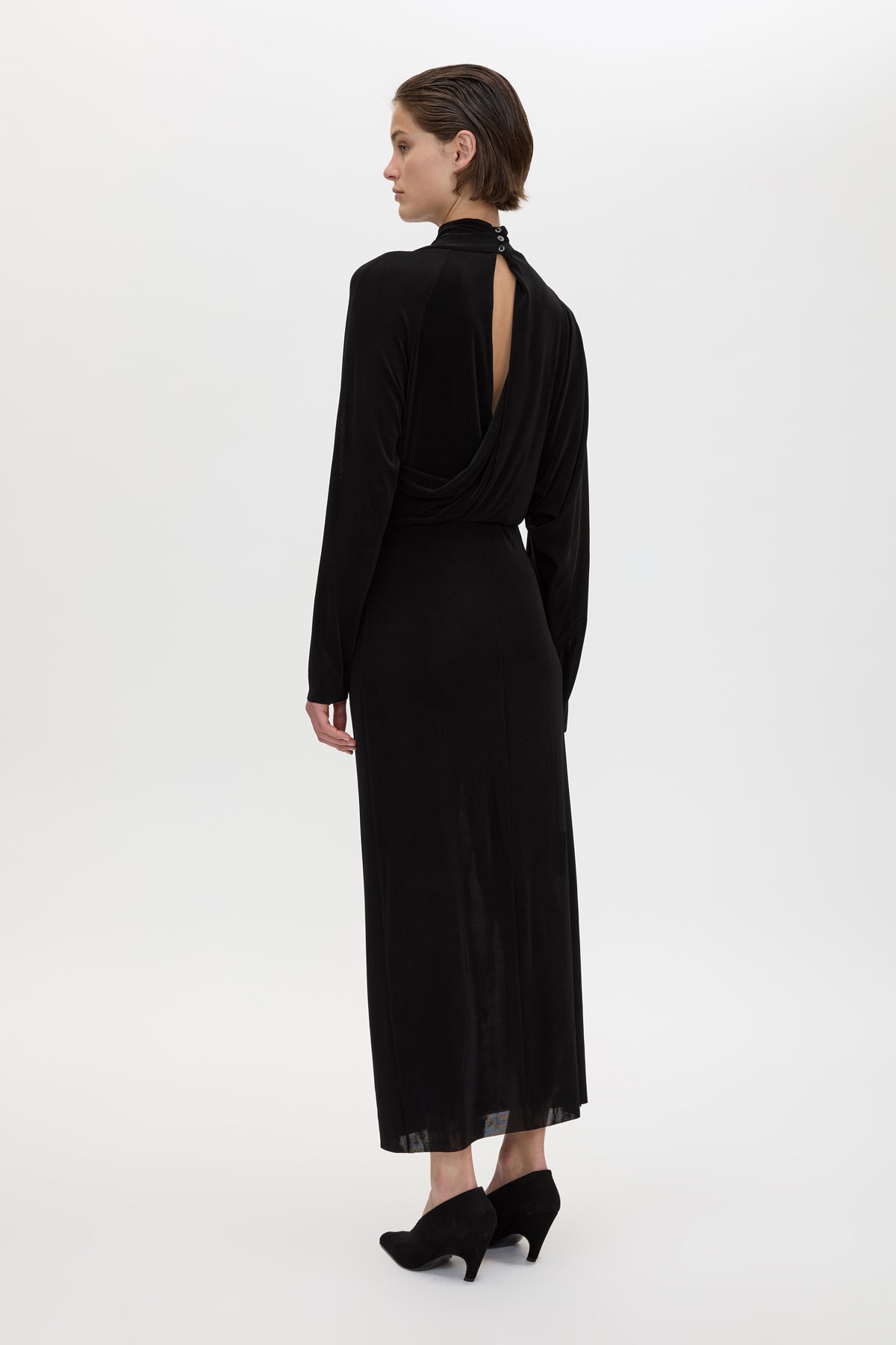 Back view CAMILLA AND MARC Ravine Midi Dress in Black with asymmetric draped neckline.