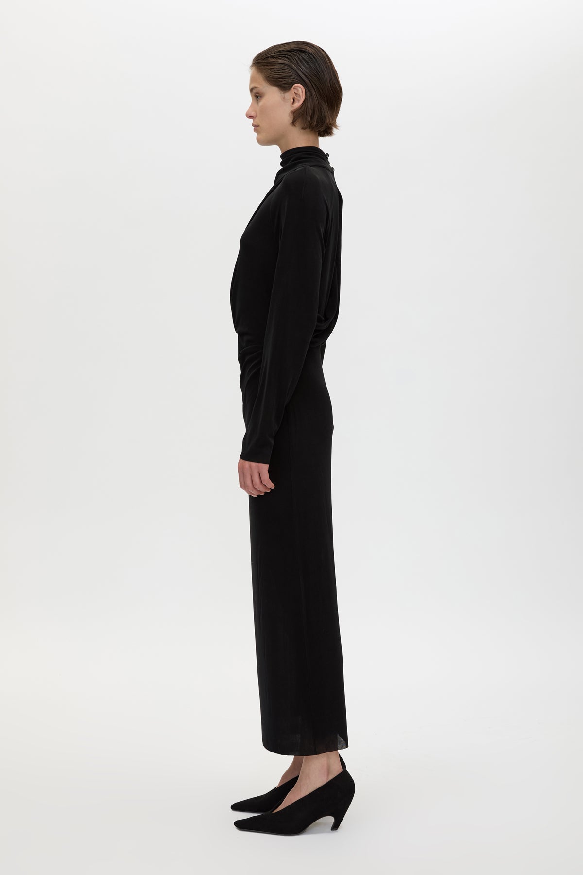 Side view CAMILLA AND MARC Ravine Midi Dress in Black with asymmetric draped neckline.
