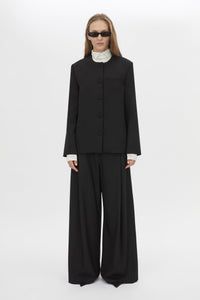 Front Styled View CAMILLA AND MARC San fitted collarless blazer in black with Front button closure.