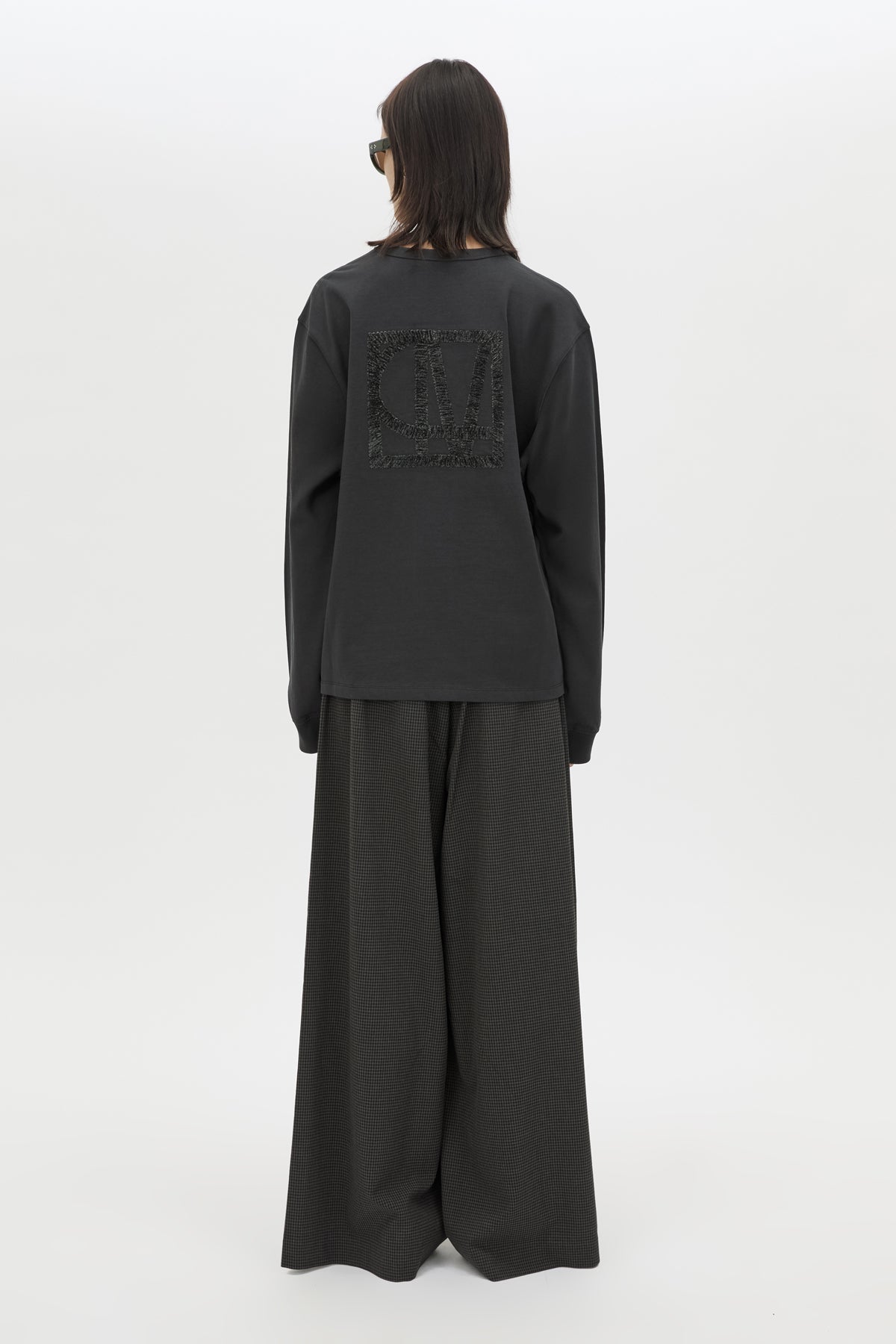 Back view CAMILLA AND MARC Studio Graphic Long Sleeve Top in Grey with boucle embroidered monogram.  