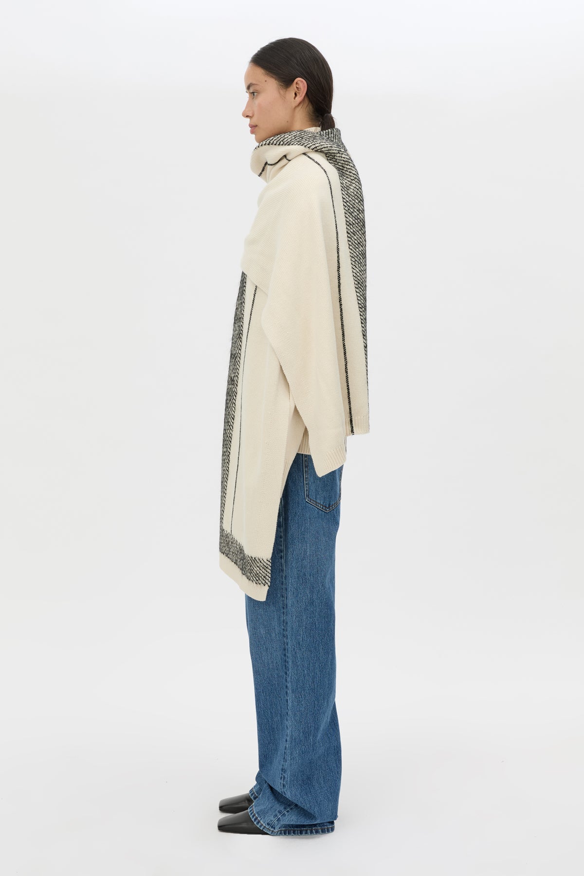 Side view CAMILLA AND MARC Tusk Knit Stripe Scarf in Black with striped jacquard graphic and Australian wool fabrication.