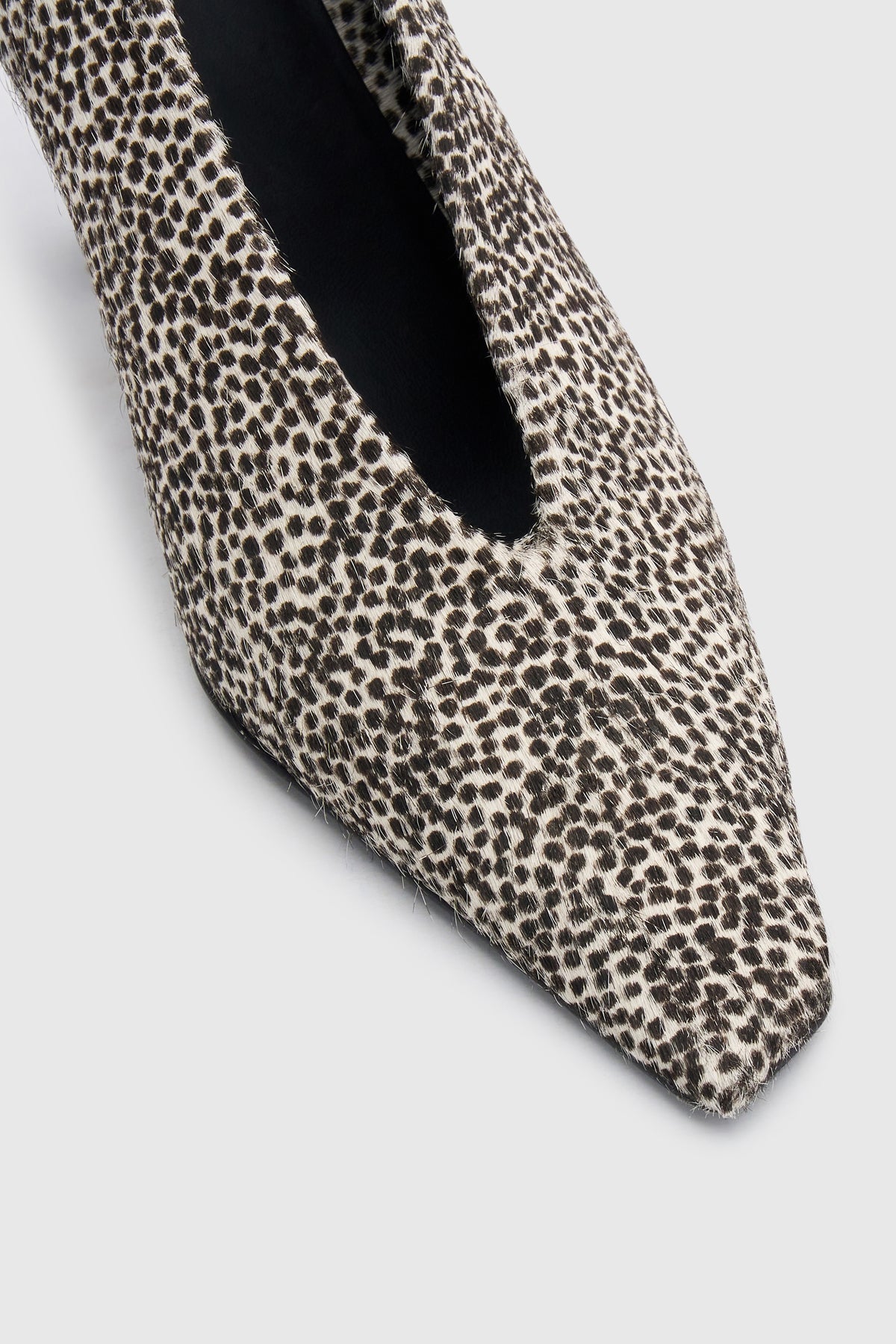 Cropped view CAMILLA AND MARC Wave Spotted Pump in Black and White with textured finish and angled heel.