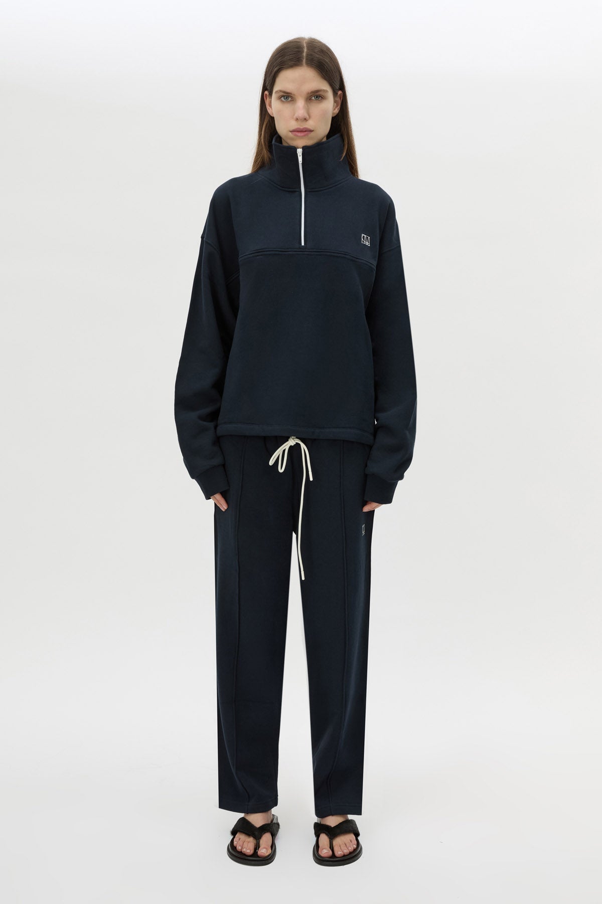 Front view CAMILLA AND MARC Zylus funnel neck pullover sweater in navy/white with contrast embroidered monogram. 