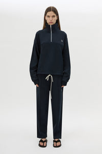 Front view CAMILLA AND MARC Zylus funnel neck pullover sweater in navy/white with contrast embroidered monogram. 