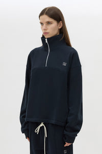Cropped view CAMILLA AND MARC Zylus funnel neck pullover sweater in navy/white with contrast embroidered monogram. 