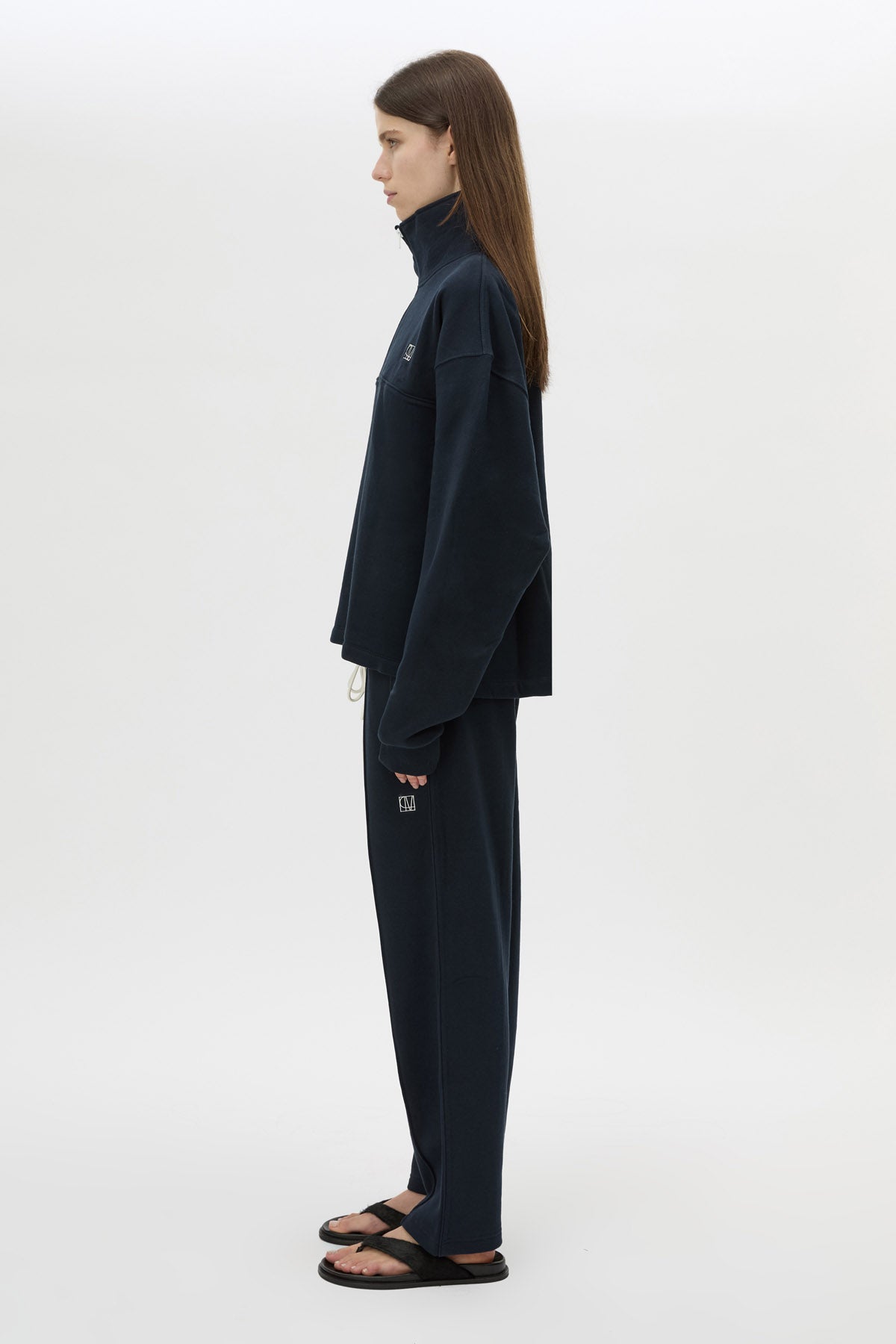 Side view CAMILLA AND MARC Zylus funnel neck pullover sweater in navy/white with contrast embroidered monogram. 